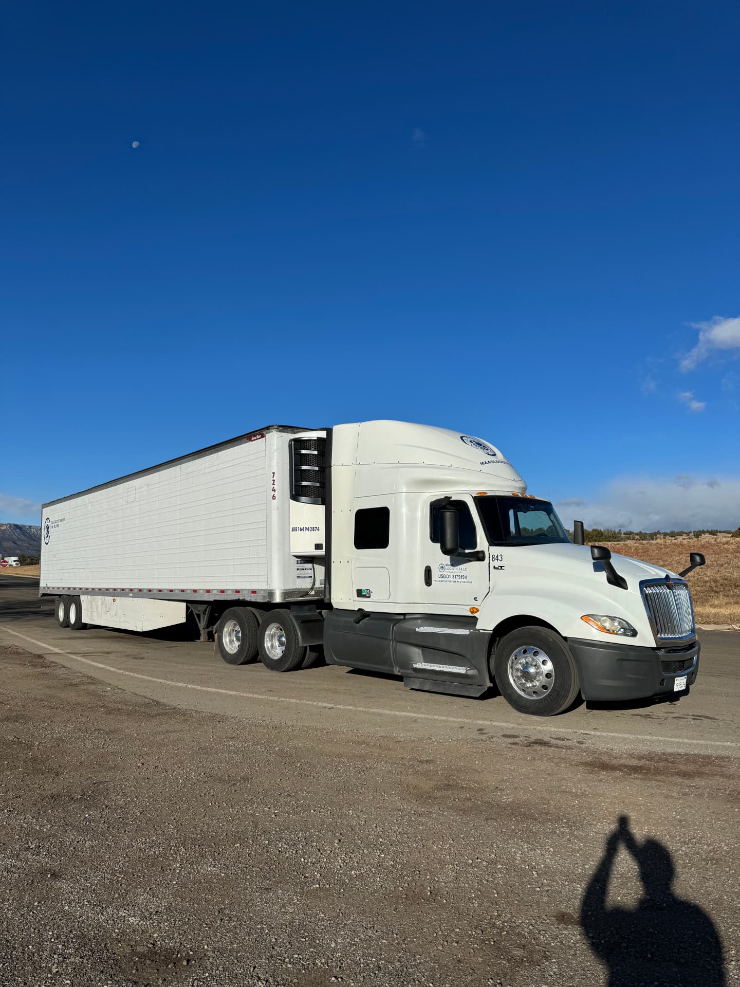 Maas Logistics tractor and 53-foot refrigerated trailer parked on a western route